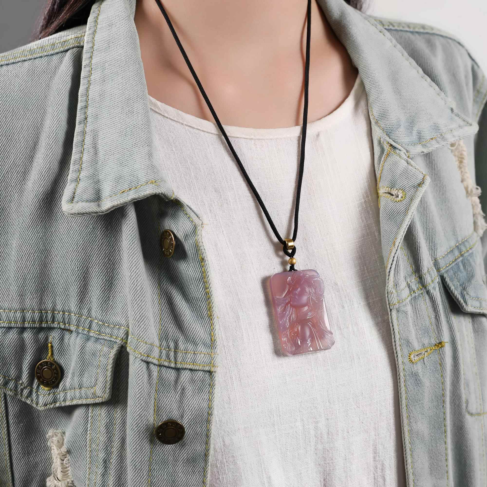 Aries purple agate necklace worn on a black cord with a light shirt and denim jacket