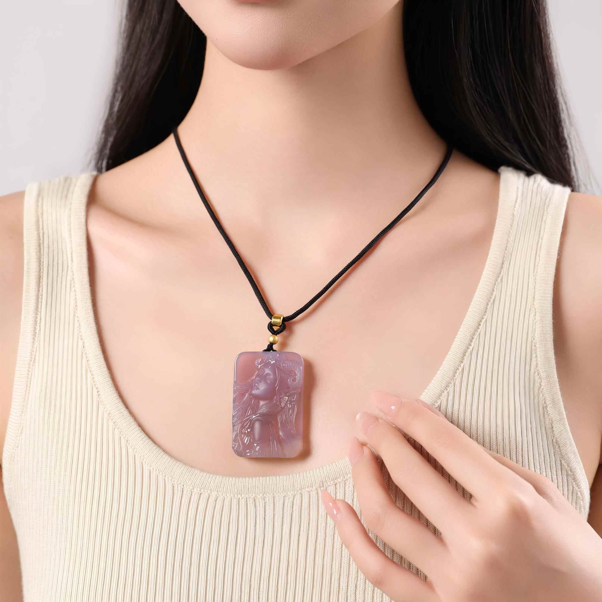 Aries purple agate necklace worn on a black cord with a cream top