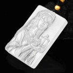 Angled view of the hand-carved white agate Libra pendant showing the relief