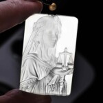 Libra white agate pendant held against light to show the carving