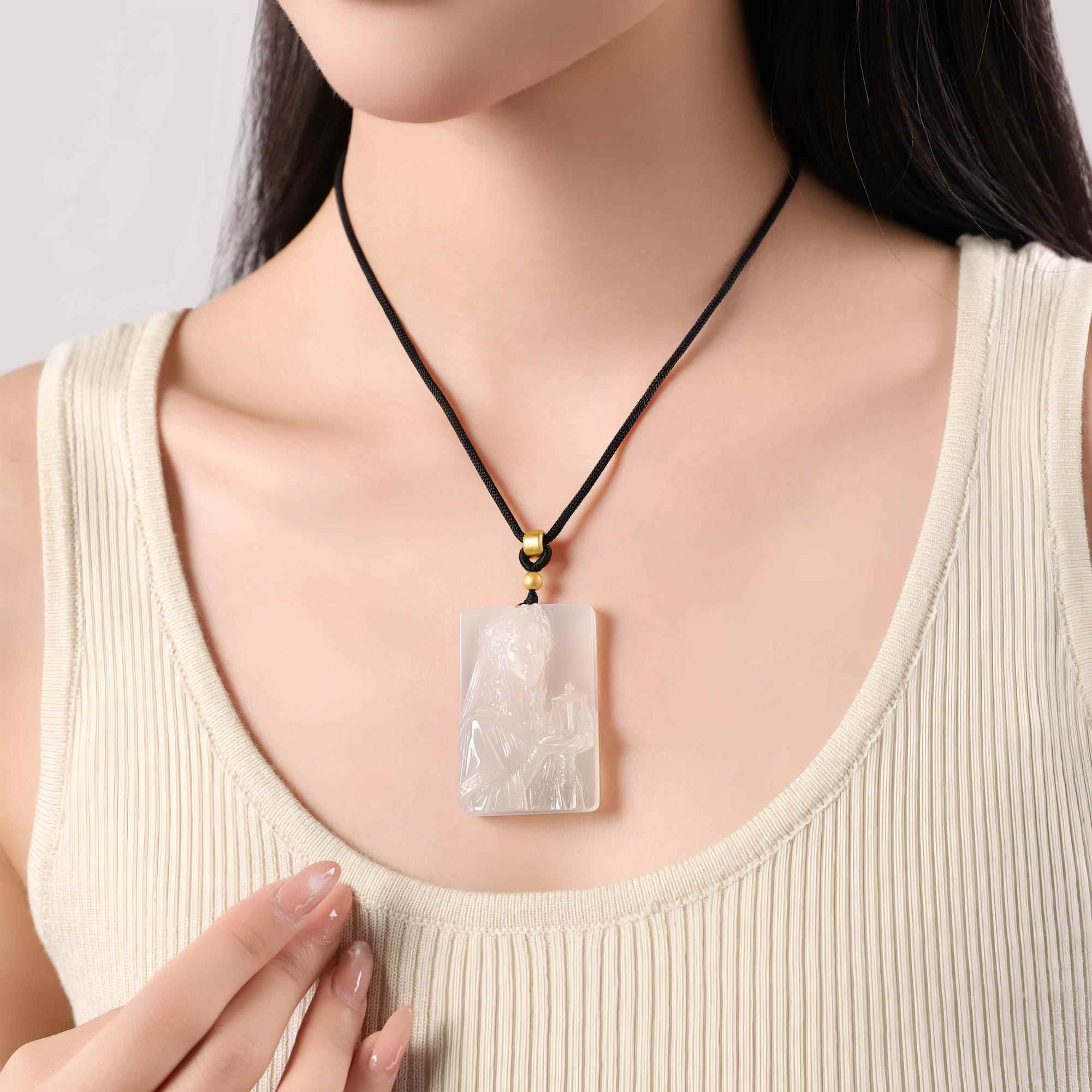 Libra white agate necklace worn on a black cord with a cream top