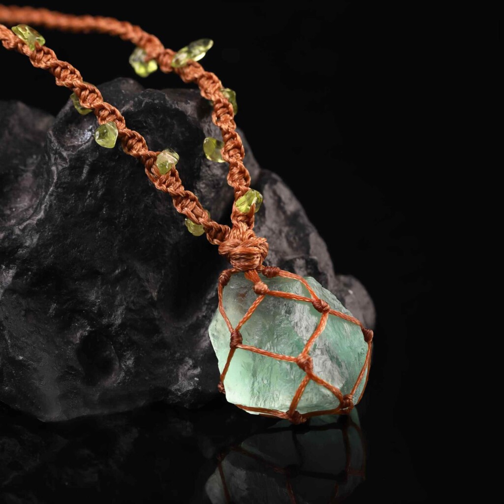 Close-up of rough green fluorite and the brown cord wrap