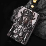 Angled view of the hand-carved black obsidian Scorpio pendant showing the relief