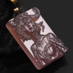 Angled view of the hand-carved purple agate Taurus pendant showing the relief